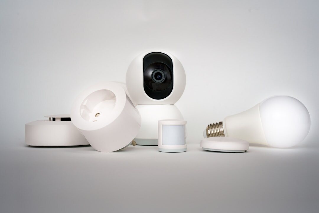 Smart home devices collection on white surface including smart speaker and connected gadgets