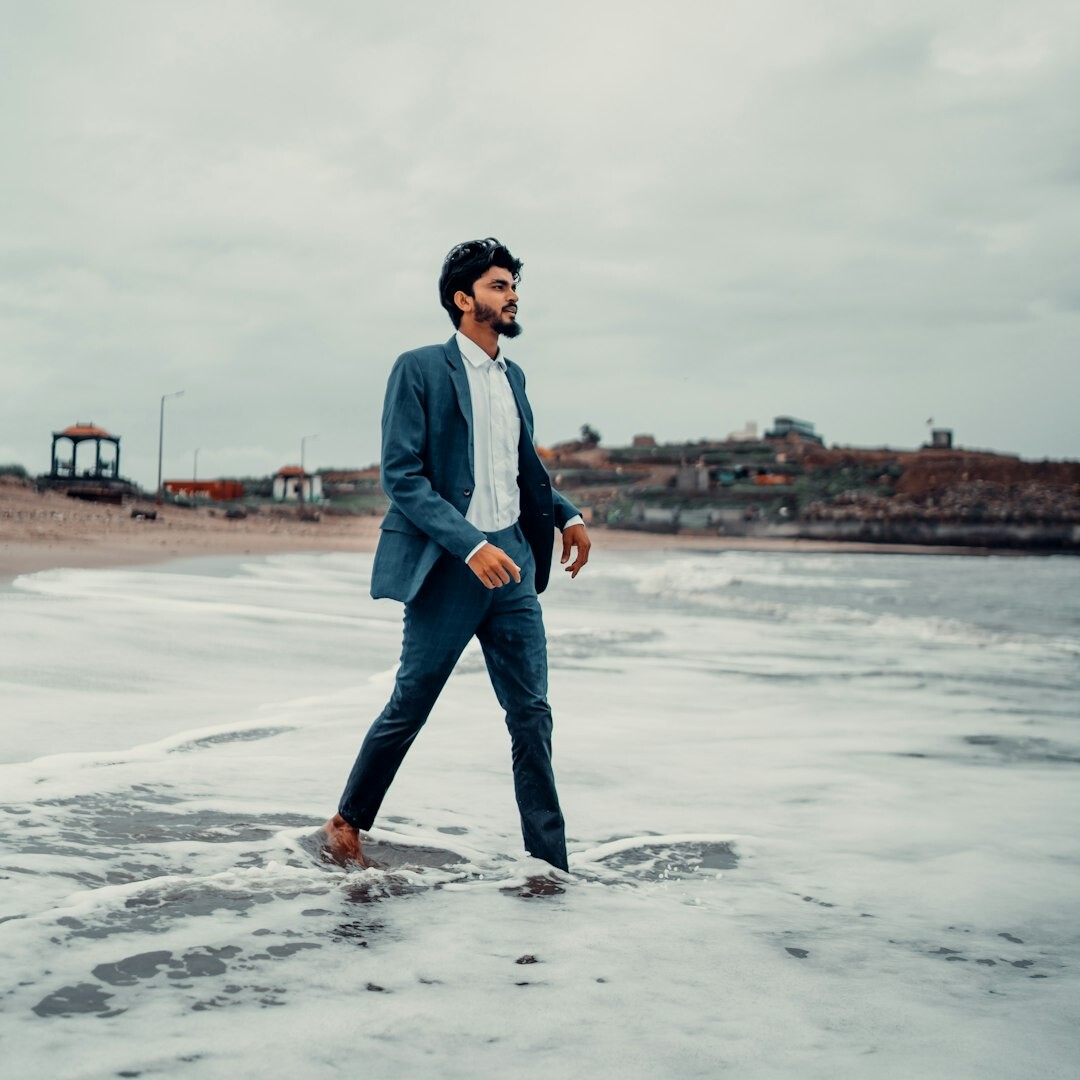 Professional Belgian man in his 40s wearing a navy suit looking confident
